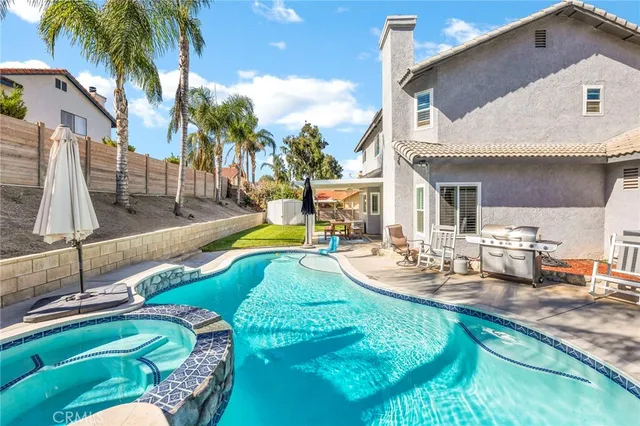 a view of a backyard with swimming pool