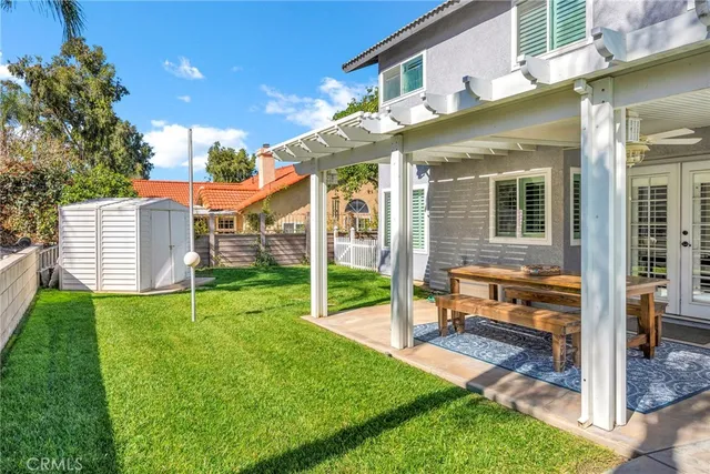 a view of a house with backyard porch and sitting area