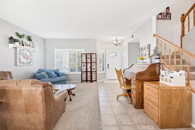 a living room with furniture and a book shelf