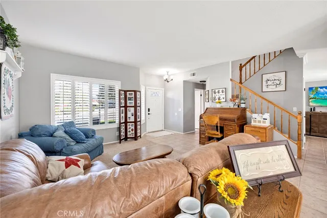 a living room with furniture fireplace and a window