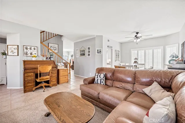 a living room with furniture and a gym