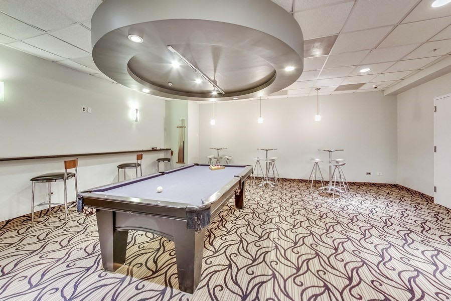 545 North Dearborn Street, Unit 1809 Chicago, IL 60654 - Photo 27 of 31 a room with furniture and wooden floor