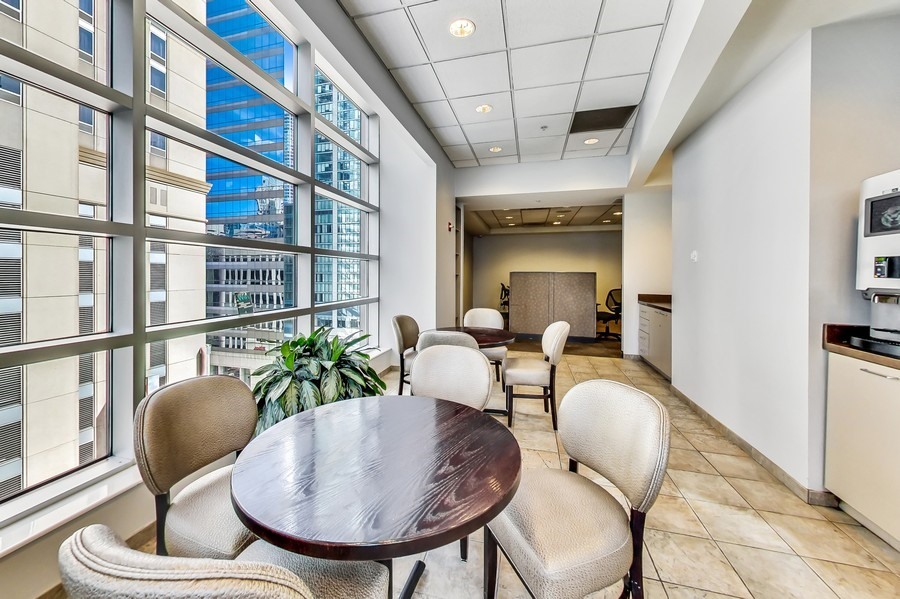 545 North Dearborn Street, Unit 1809 Chicago, IL 60654 - Photo 31 of 31 a dining room with furniture a rug and wooden floor