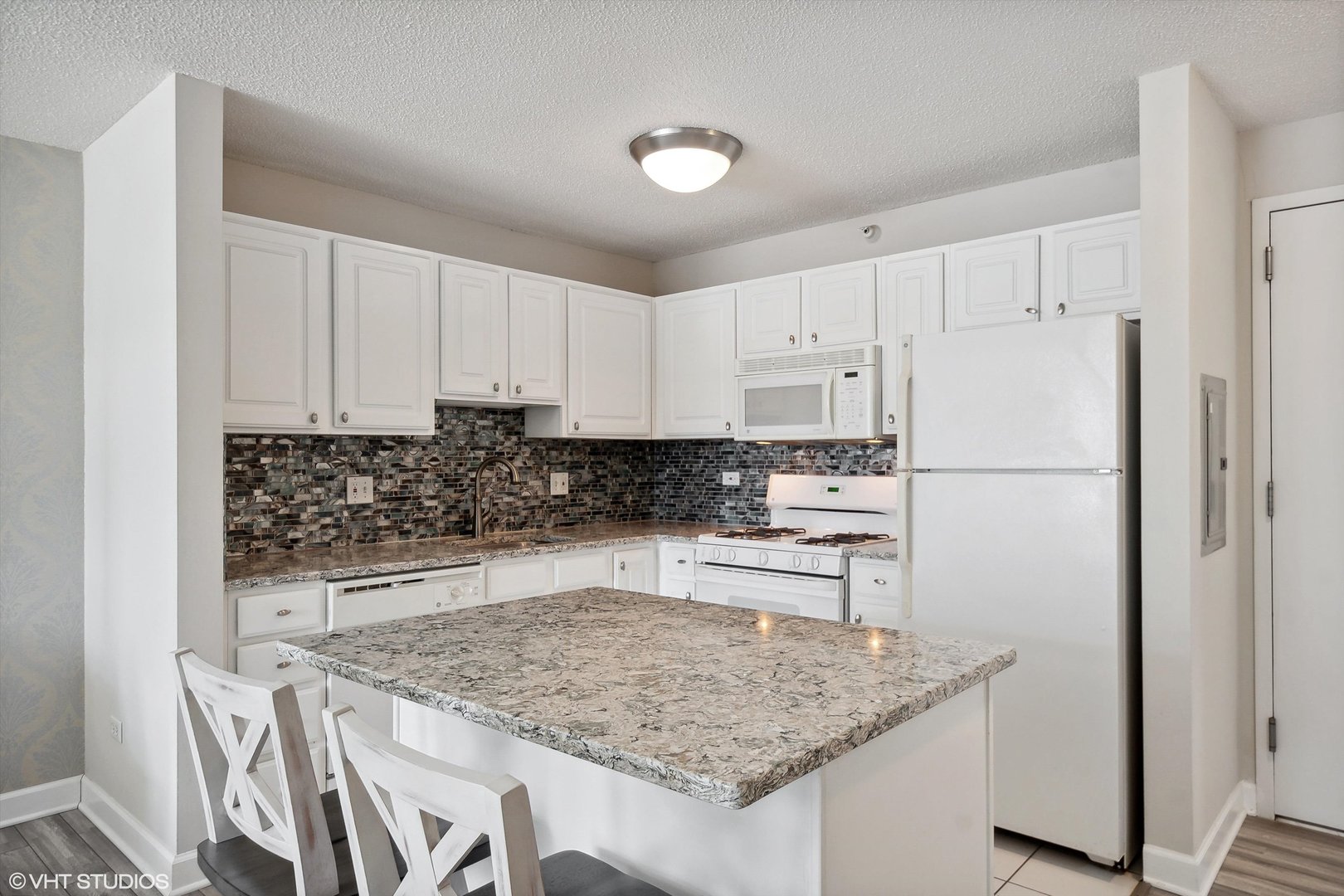 545 North Dearborn Street, Unit 1809 Chicago, IL 60654 - Photo 7 of 31 a kitchen with stainless steel appliances granite countertop a sink stove and refrigerator