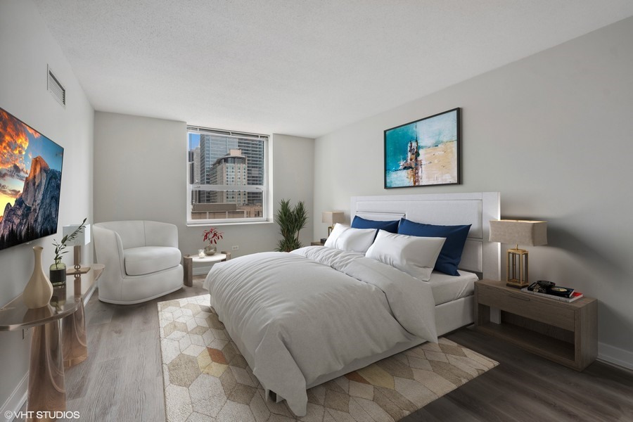 545 North Dearborn Street, Unit 1809 Chicago, IL 60654 - Photo 8 of 31 a bedroom with bed and a couch
