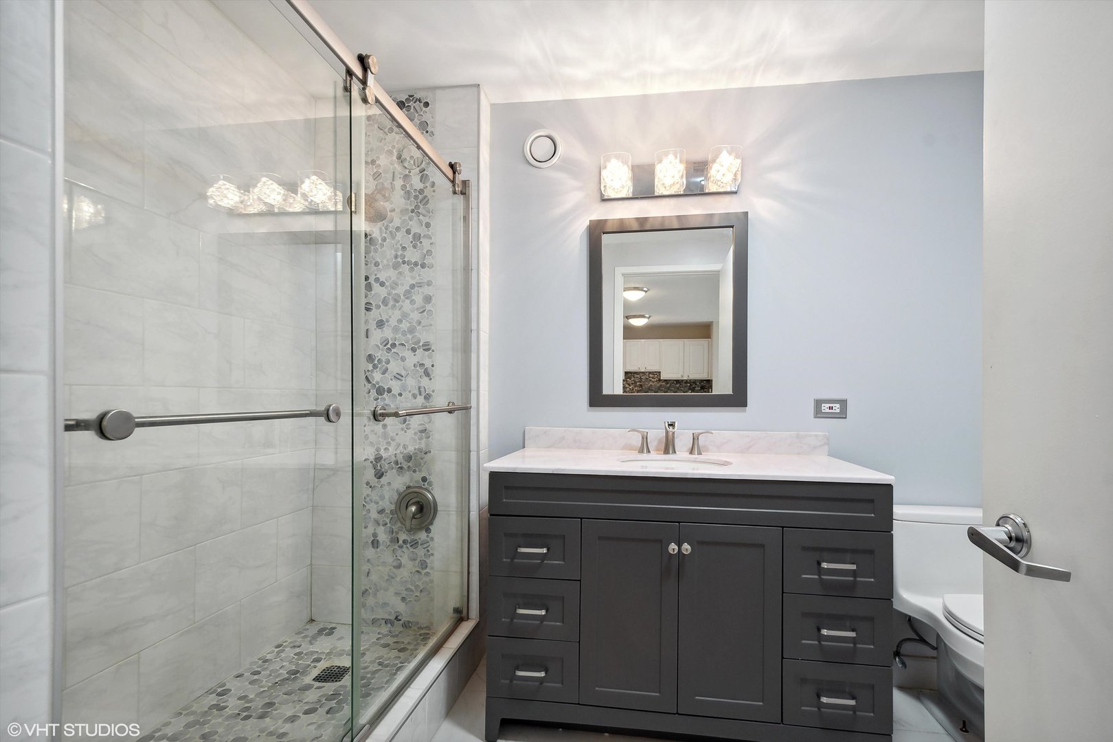 545 North Dearborn Street, Unit 1809 Chicago, IL 60654 - Photo 9 of 31 a bathroom with a sink vanity granite shower and a mirror