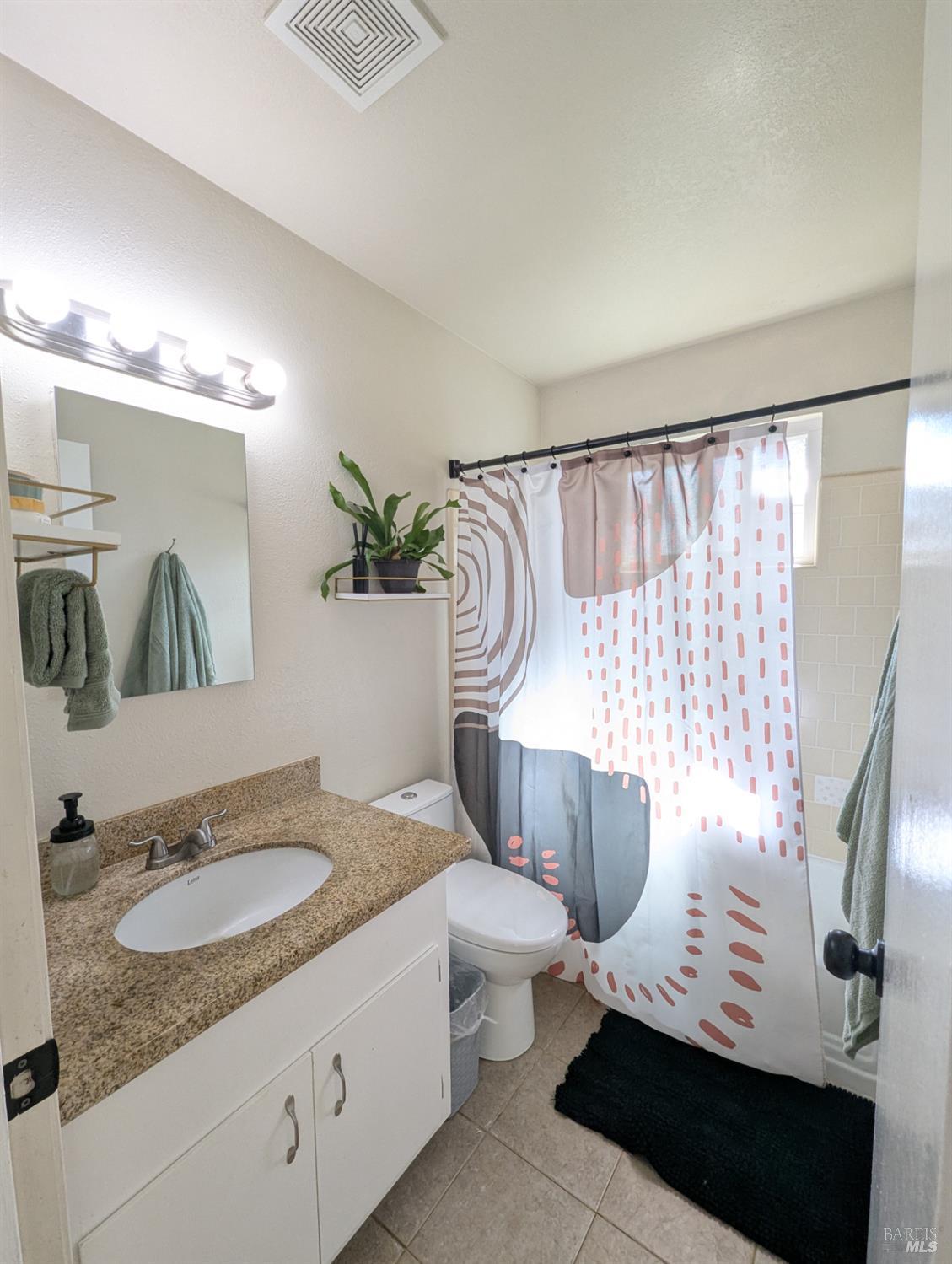 112 East Agua Caliente Road Sonoma, CA 95476 - Photo 12 of 20 a bathroom with a granite countertop sink and a mirror