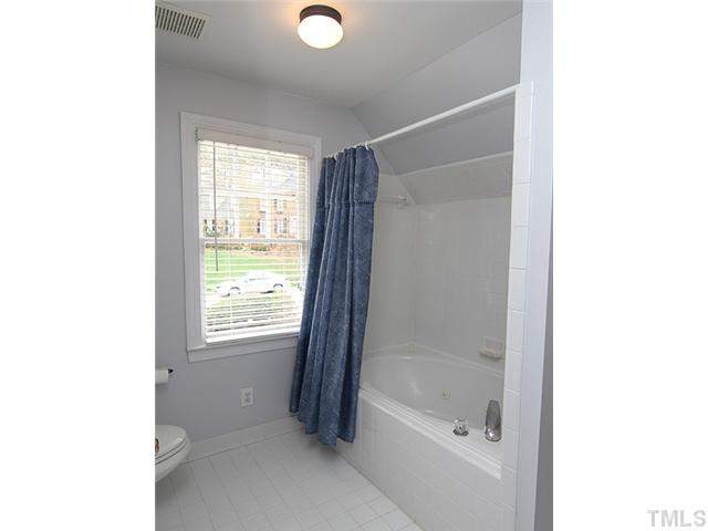 7729 Sandy Bottom Way Raleigh, NC 27613 - Photo 18 of 25 a bathroom with a bathtub and a shower