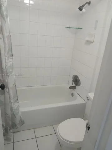 a white toilet and tub sitting next to a bath tub