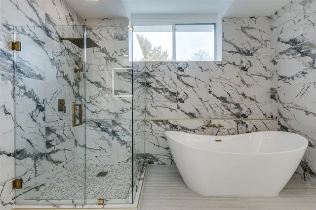a bathroom with a bathtub and shower