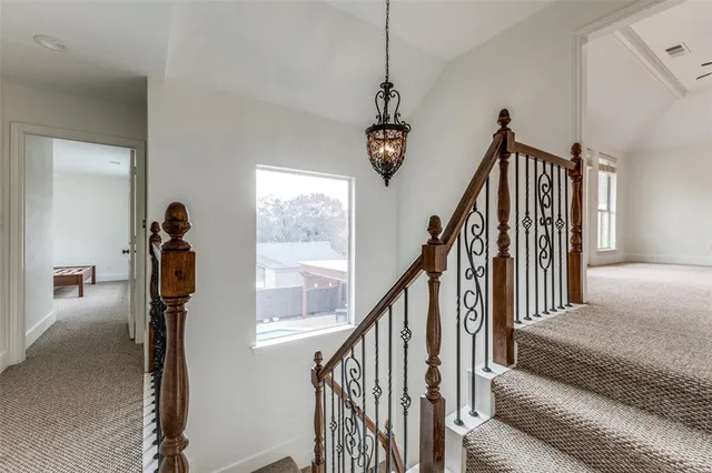 a view of an empty room with a window and a kitchen