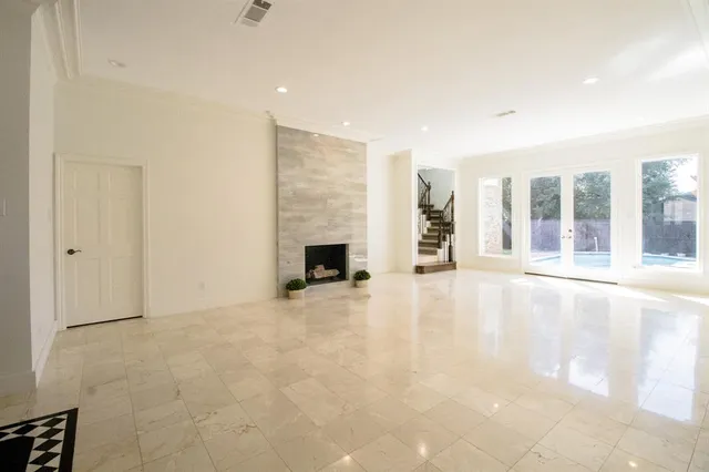 a view of a kitchen with kitchen island a sink stainless steel appliances wooden floor and a counter top space