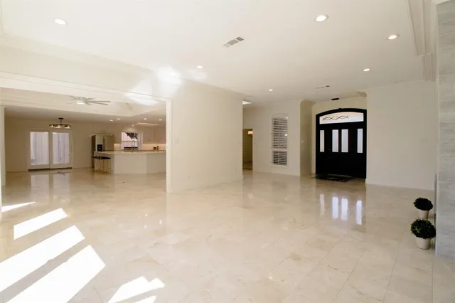 a large white kitchen with a large window