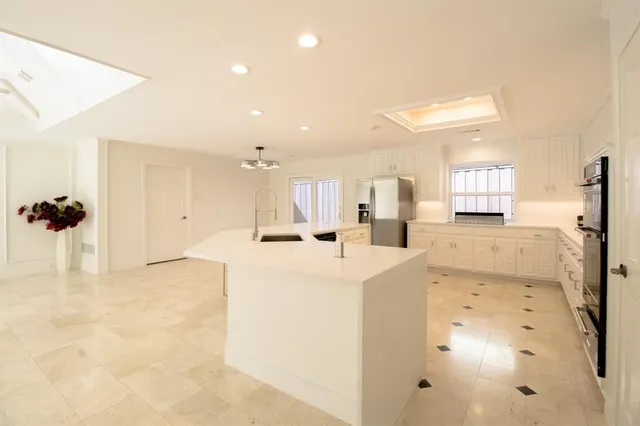 a bathroom with a granite countertop sink mirror vanity and toilet