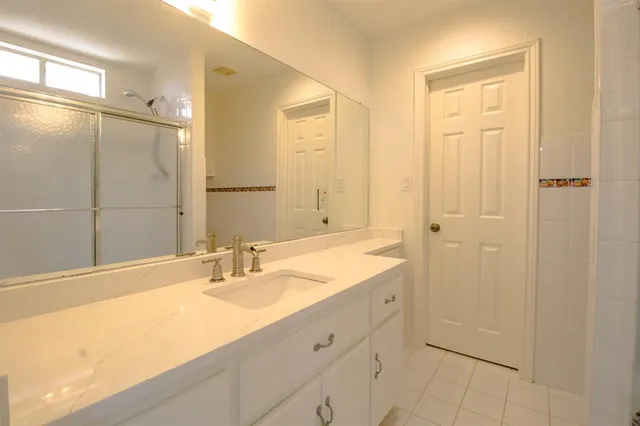a living room with furniture a flat screen tv and a large window