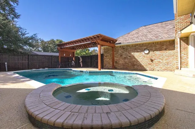 a large kitchen with a table and chairs