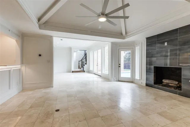 a view of a livingroom with a chandelier fan and windows