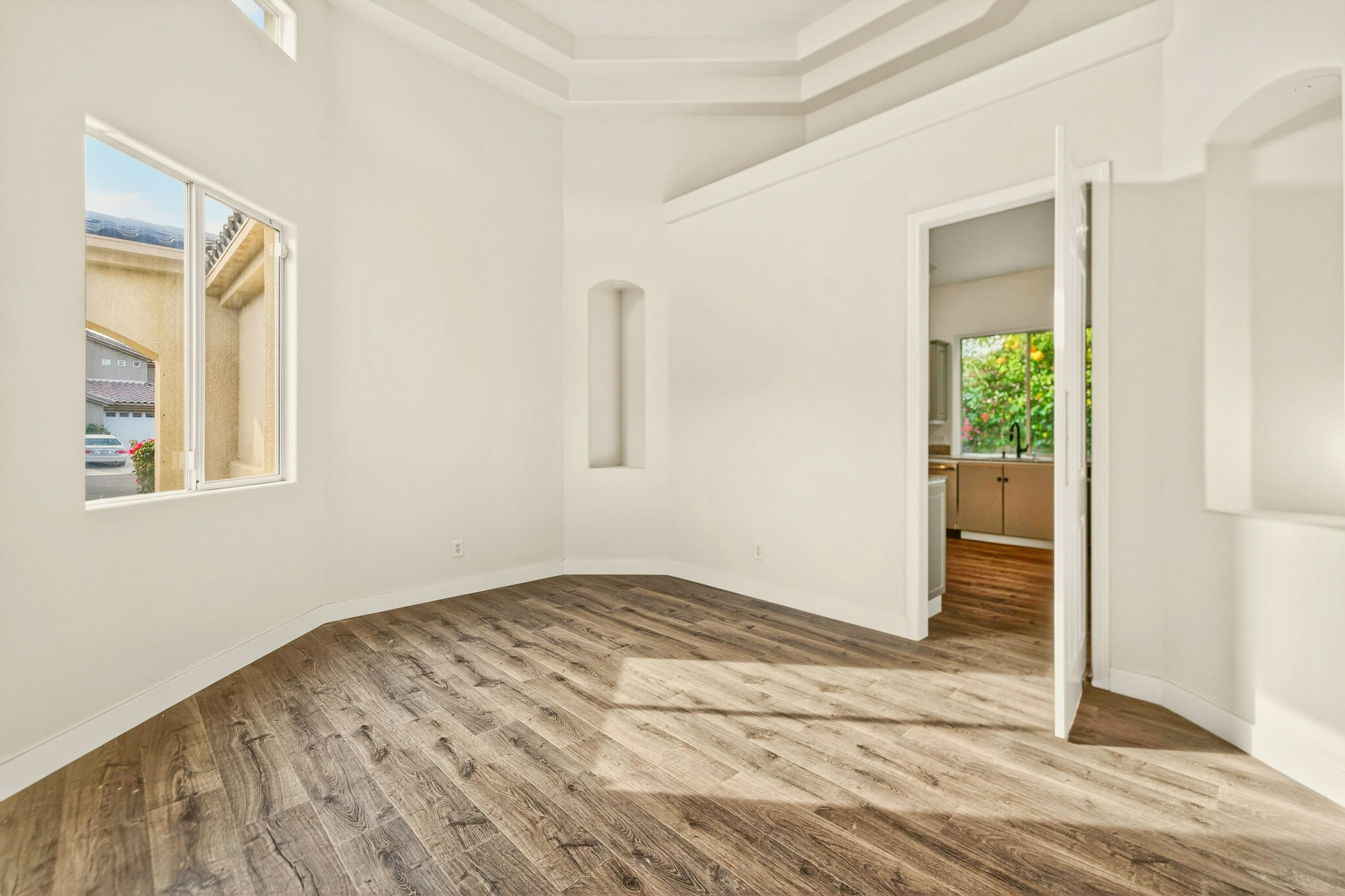 6 Queens Court Rancho Mirage, CA 92270 - Photo 15 of 28 a view of empty room with wooden floor and fan