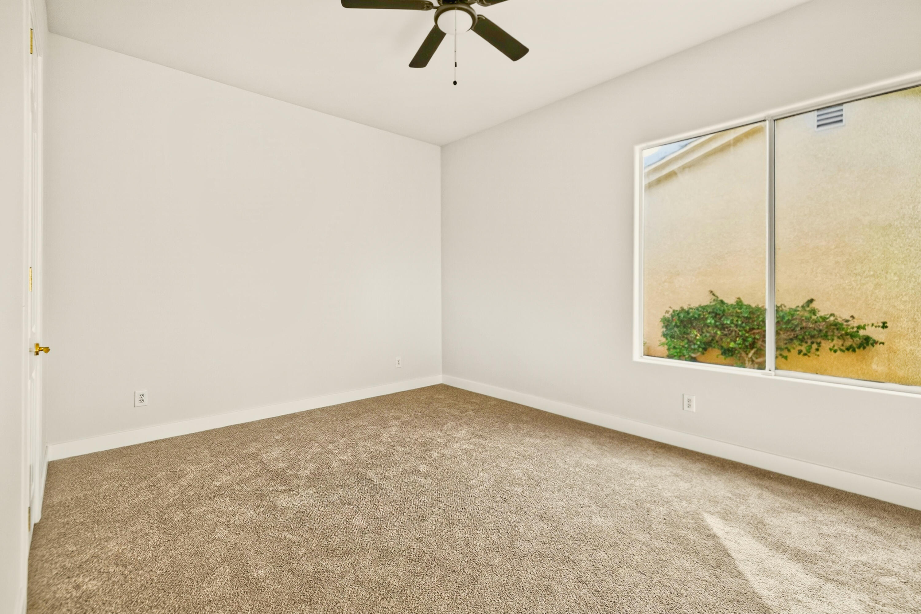 6 Queens Court Rancho Mirage, CA 92270 - Photo 18 of 28 an empty room with a window