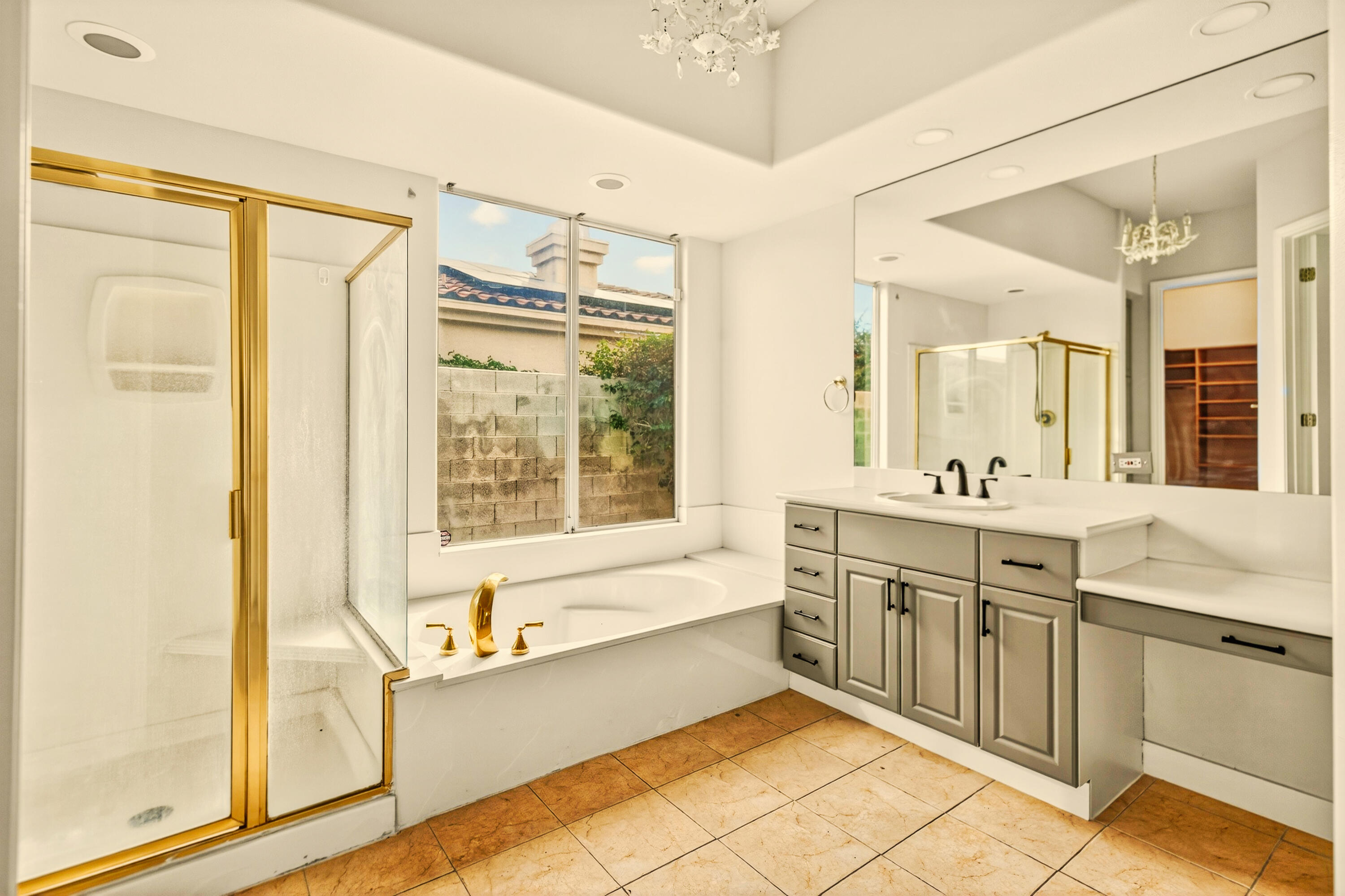 6 Queens Court Rancho Mirage, CA 92270 - Photo 23 of 28 a spacious bathroom with a granite countertop tub sink shower and mirror