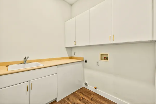 a room with a sink and cabinets