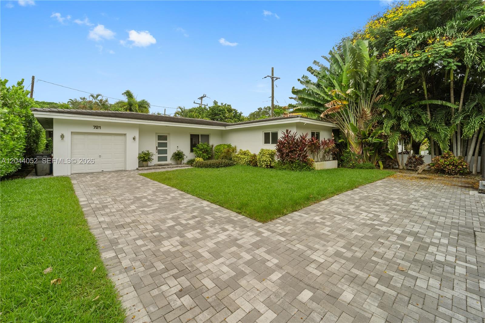 721 Bird Road Coral Gables, FL 33146 - Photo 20 of 24 a view of house with a big yard and potted plants