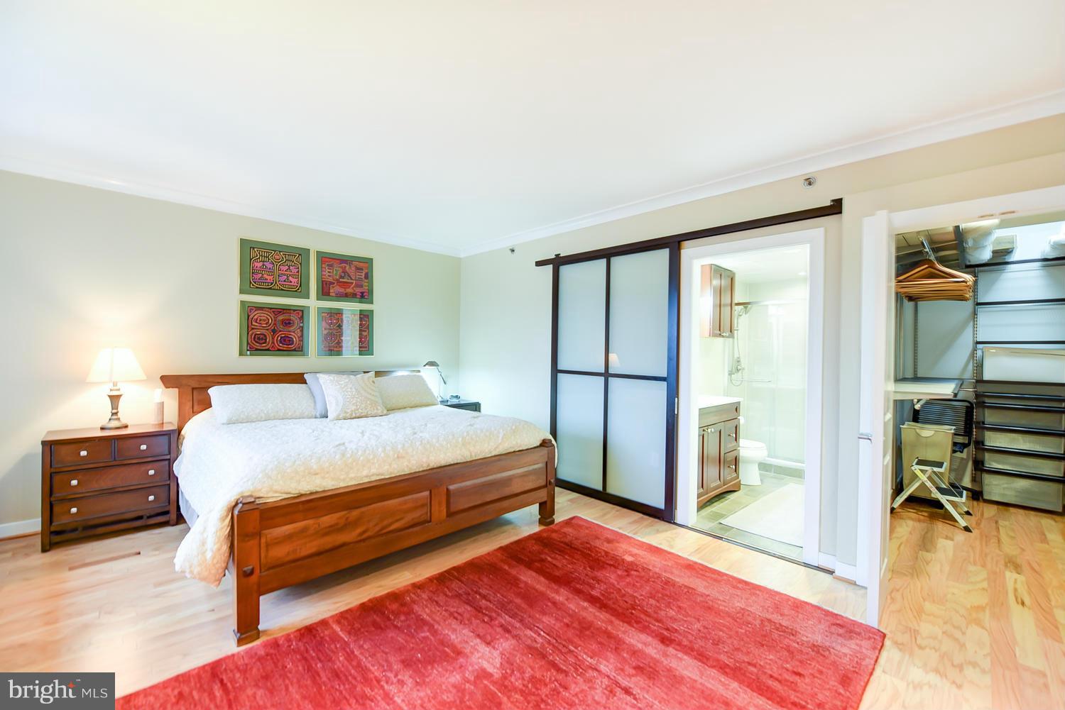 777 7th Street Northwest, Unit 1113 Washington, DC 20001 - Photo 14 of 30 a spacious bedroom with a bed and a dresser next to a window