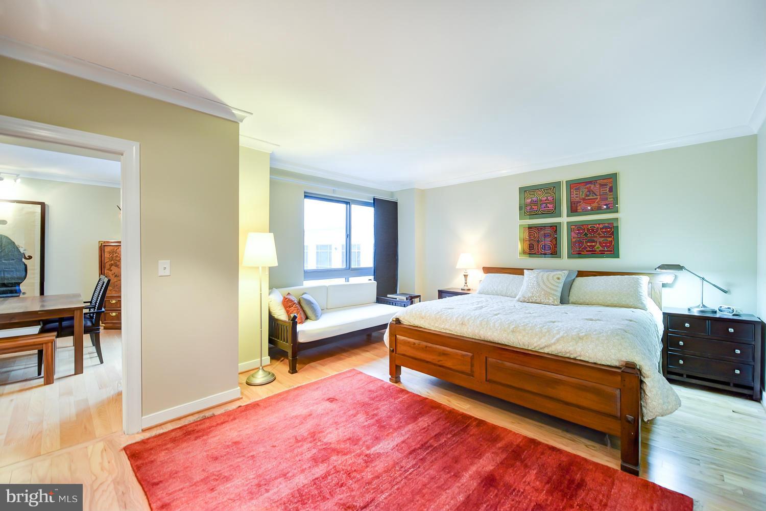 777 7th Street Northwest, Unit 1113 Washington, DC 20001 - Photo 15 of 30 a bedroom with a bed and wooden floor