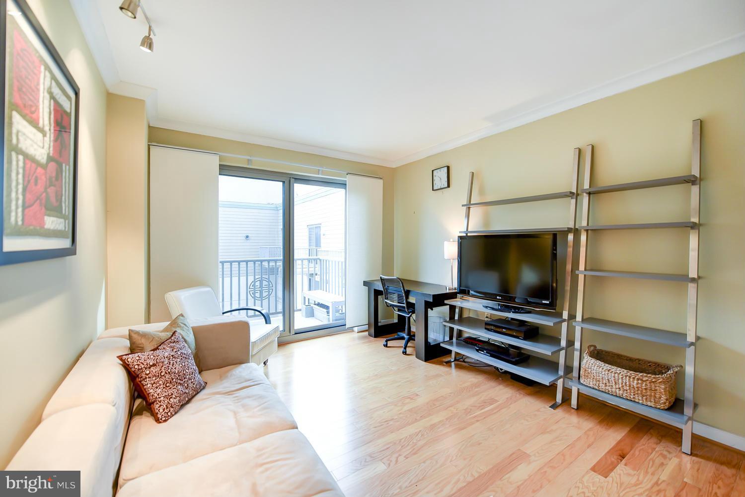 777 7th Street Northwest, Unit 1113 Washington, DC 20001 - Photo 19 of 30 a living room with furniture and a flat screen tv