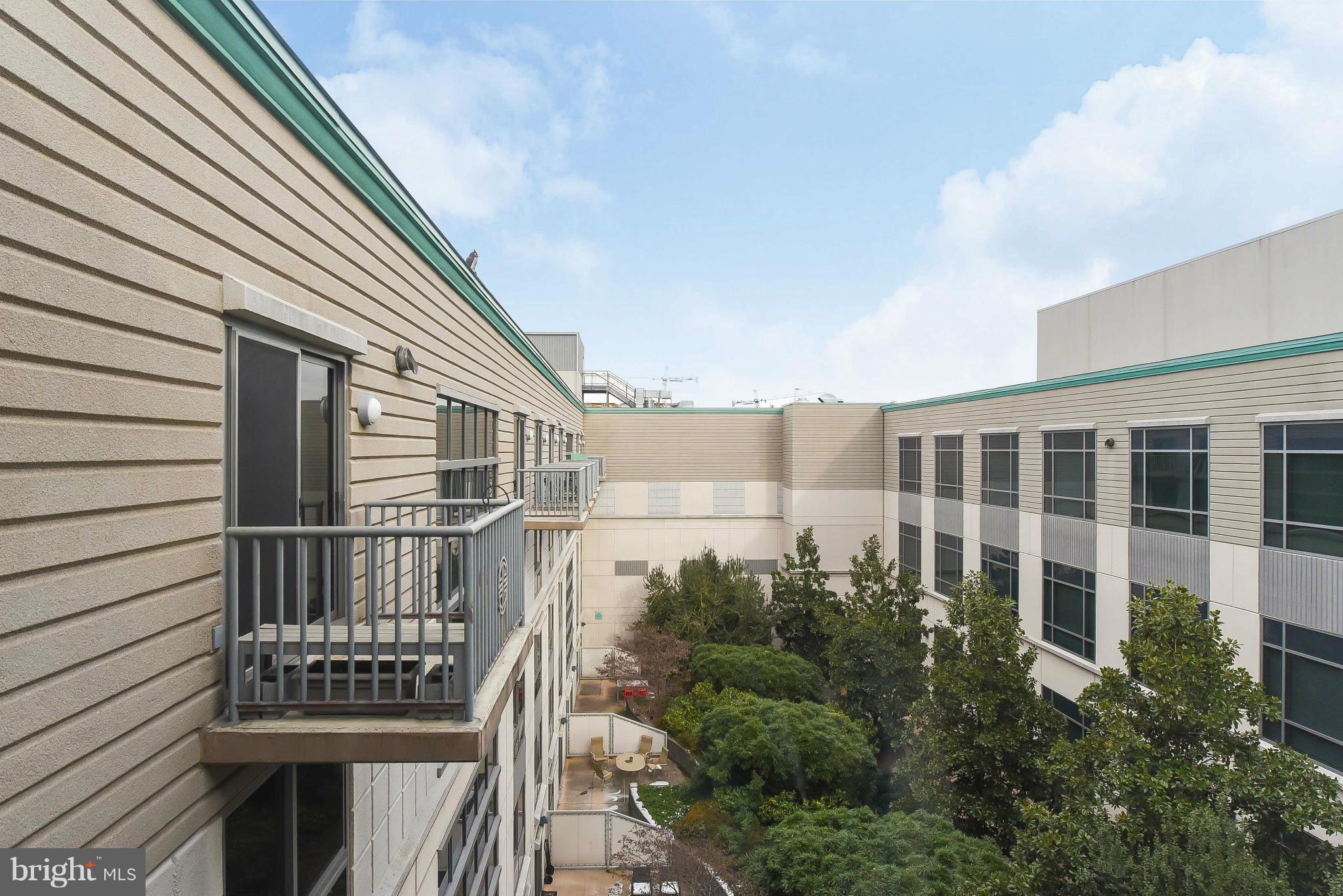 777 7th Street Northwest, Unit 1113 Washington, DC 20001 - Photo 23 of 30 a front view of a house with a garden