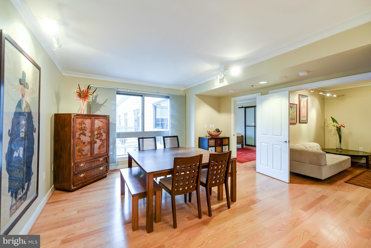 777 7th Street Northwest, Unit 1113 Washington, DC 20001 - Photo 4 of 30 a view of a dining room with furniture window and wooden floor