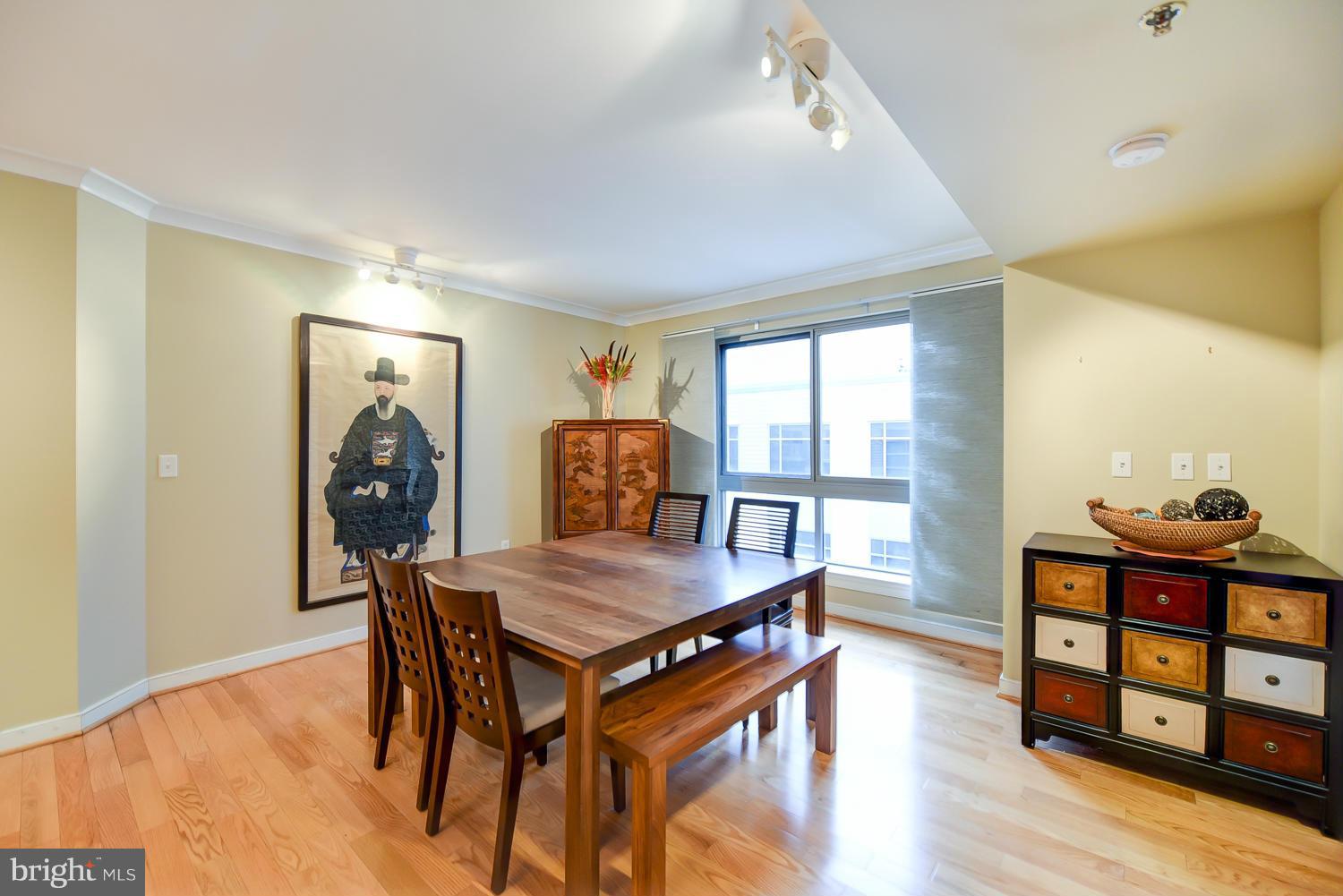 777 7th Street Northwest, Unit 1113 Washington, DC 20001 - Photo 8 of 30 a view of a dining room with furniture and wooden floor
