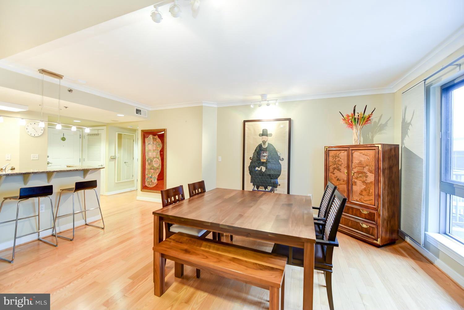 777 7th Street Northwest, Unit 1113 Washington, DC 20001 - Photo 9 of 30 a view of a dining room with furniture and wooden floor