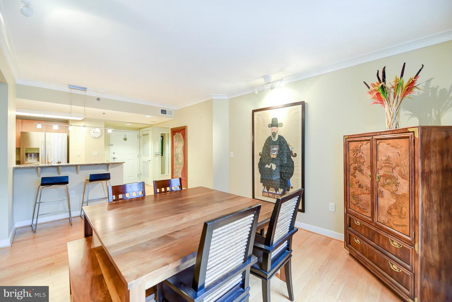 777 7th Street Northwest, Unit 1113 Washington, DC 20001 - Photo 10 of 30 a dining room with furniture and a mirror