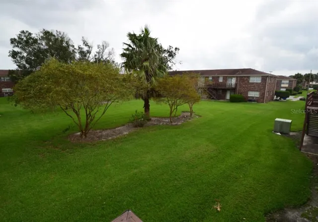 a view of a big house with a big yard
