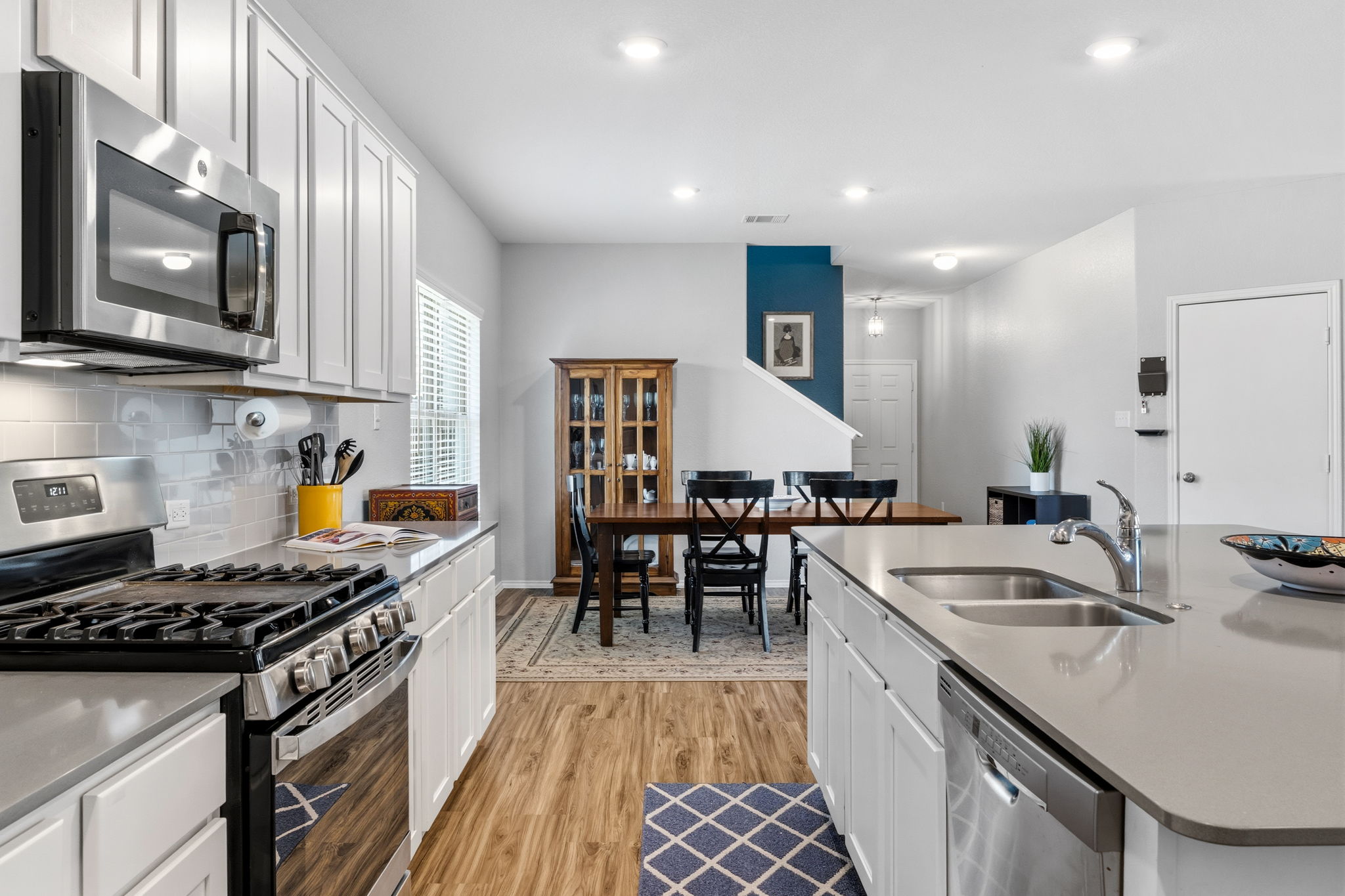 3101 Fresh Spring Road Pflugerville, TX 78660 - Photo 6 of 39 Timeless wood look luxury vinyl plank floors provide for a warm contrast to the kitchen color scheme.