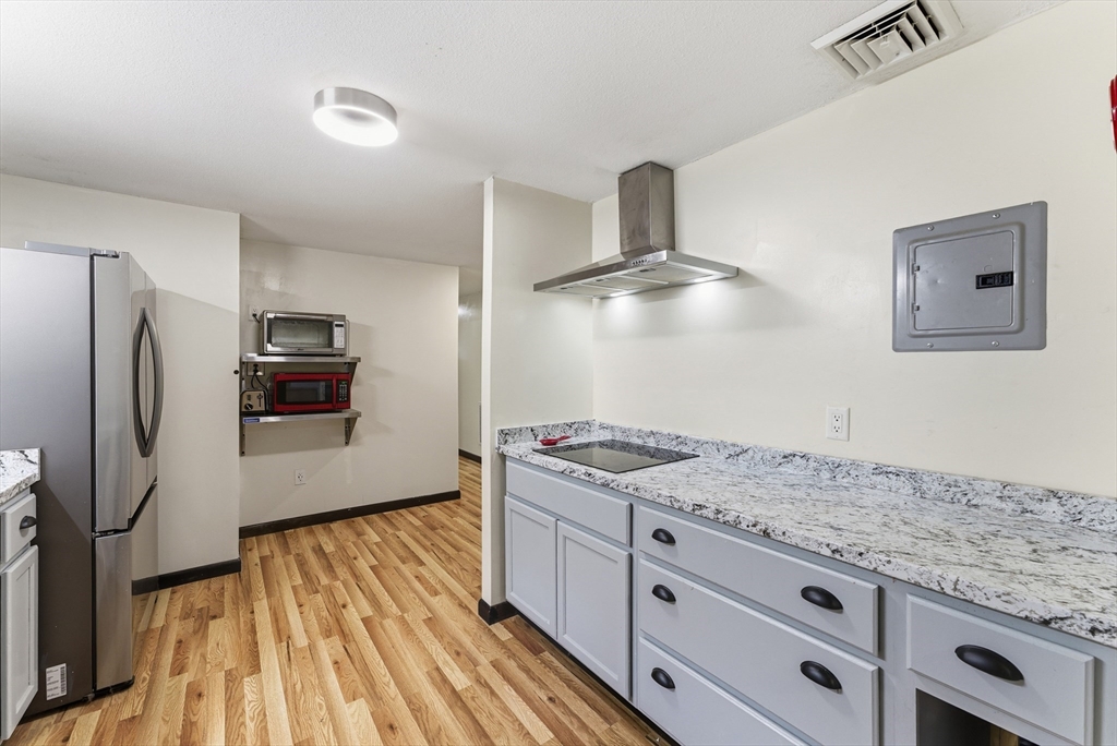 193 Roy Street Springfield, MA 01104 - Photo 12 of 40 a kitchen with stainless steel appliances granite countertop a refrigerator and a stove top oven