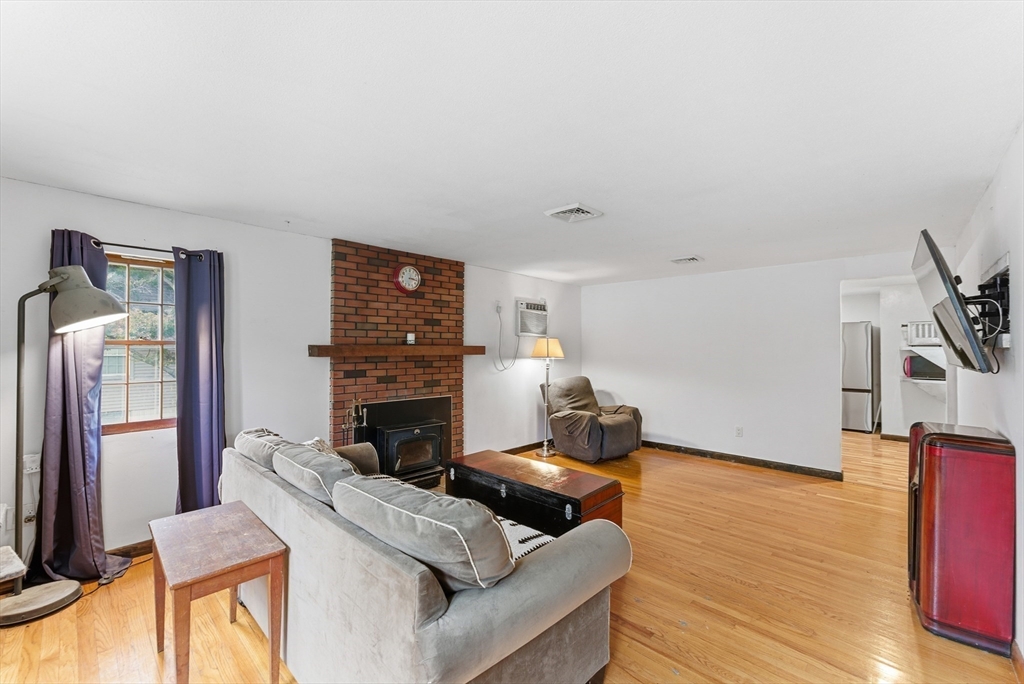 193 Roy Street Springfield, MA 01104 - Photo 15 of 40 a living room with furniture and a fireplace