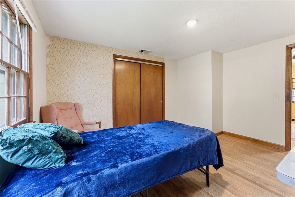 193 Roy Street Springfield, MA 01104 - Photo 20 of 40 a bedroom with a bed and wooden floor