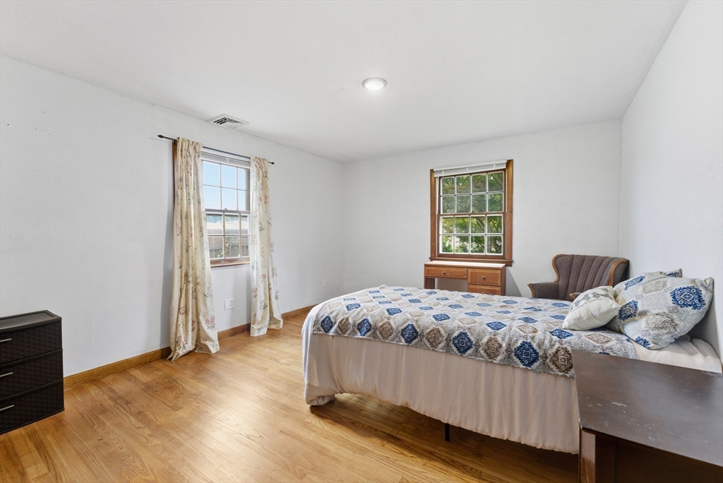 193 Roy Street Springfield, MA 01104 - Photo 21 of 40 a bedroom with a bed and wooden floor