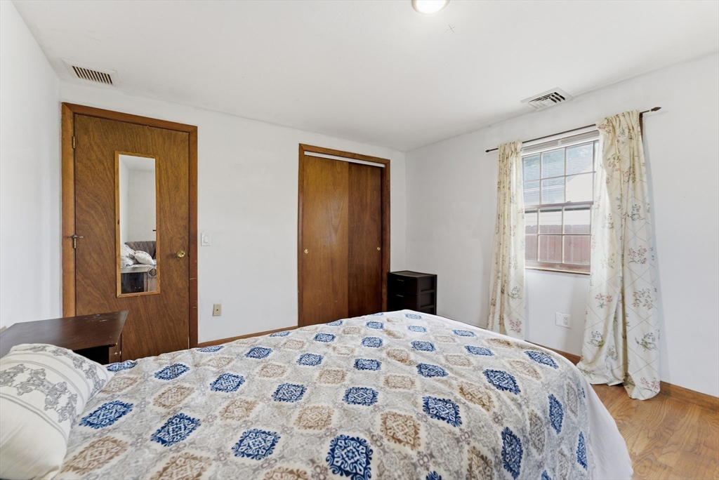 193 Roy Street Springfield, MA 01104 - Photo 24 of 40 a bedroom with a bed and a dresser