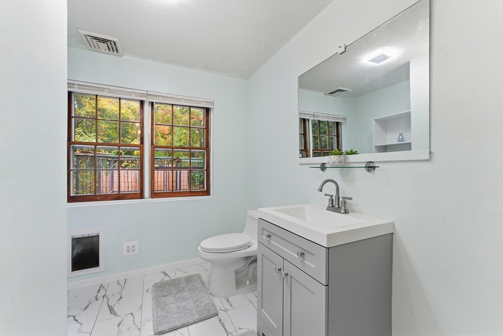 193 Roy Street Springfield, MA 01104 - Photo 27 of 40 a bathroom with a sink toilet and mirror