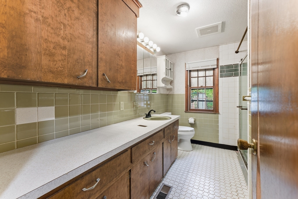 193 Roy Street Springfield, MA 01104 - Photo 29 of 40 a bathroom with a sink a toilet and shower