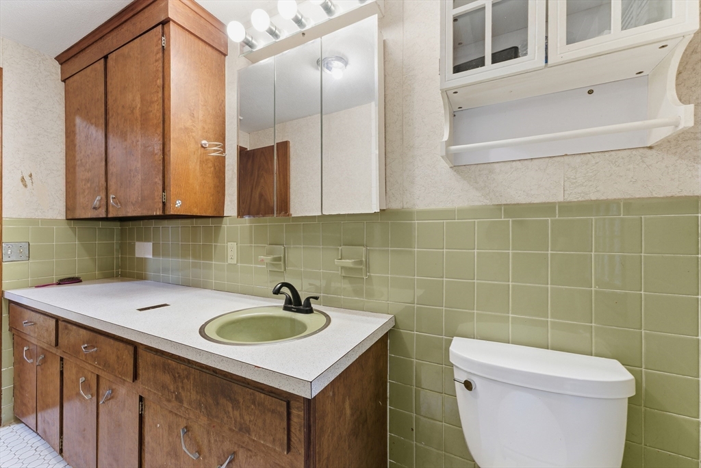 193 Roy Street Springfield, MA 01104 - Photo 30 of 40 a bathroom with a sink a toilet and mirror
