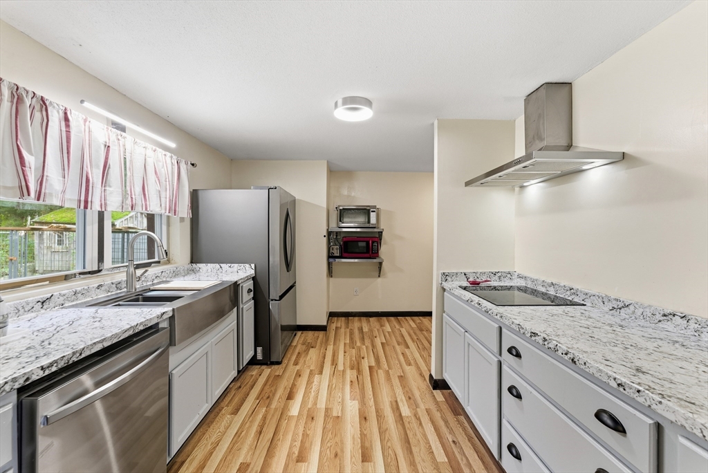 193 Roy Street Springfield, MA 01104 - Photo 7 of 40 a kitchen with granite countertop stainless steel appliances a sink stove and refrigerator