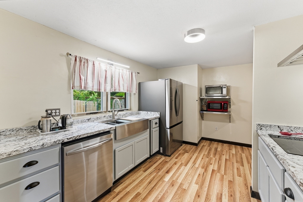 193 Roy Street Springfield, MA 01104 - Photo 8 of 40 a kitchen with stainless steel appliances granite countertop a sink stove and refrigerator