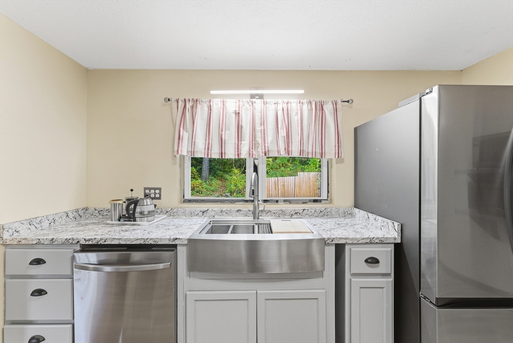 193 Roy Street Springfield, MA 01104 - Photo 10 of 40 a kitchen with stainless steel appliances granite countertop a sink and a refrigerator