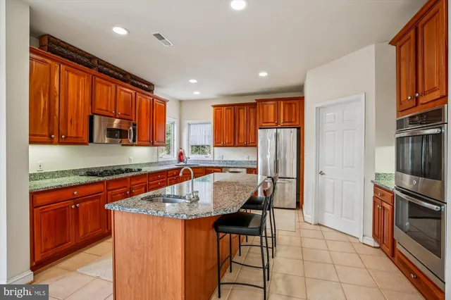 a bathroom with a double vanity sink mirror and toilet