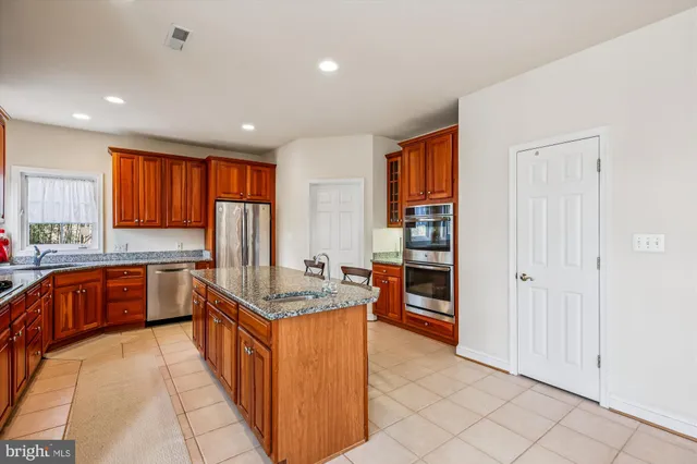 a bedroom with a bed chair and a window