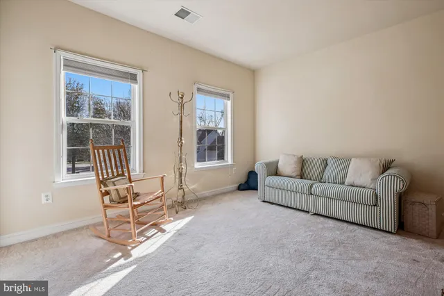 a view of a patio with couches table and chairs and potted plants